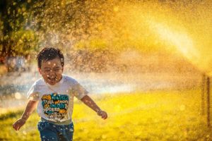 child in sprinkler